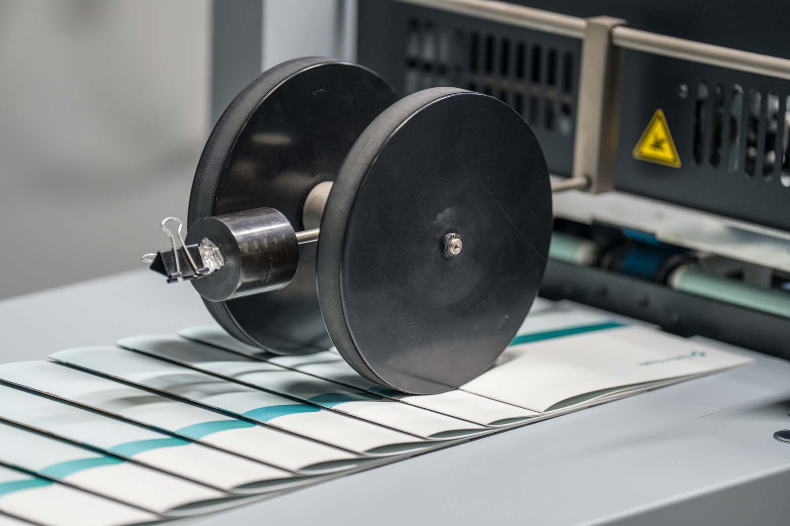 Our press folds the pages to a saddle stitched newsletter and prepares for finishing at our Bacchus Press facility.