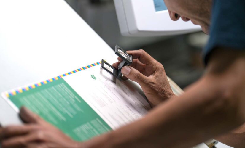 Bacchus Press technician reviews the color accuracy and detail of a proof for quality control.